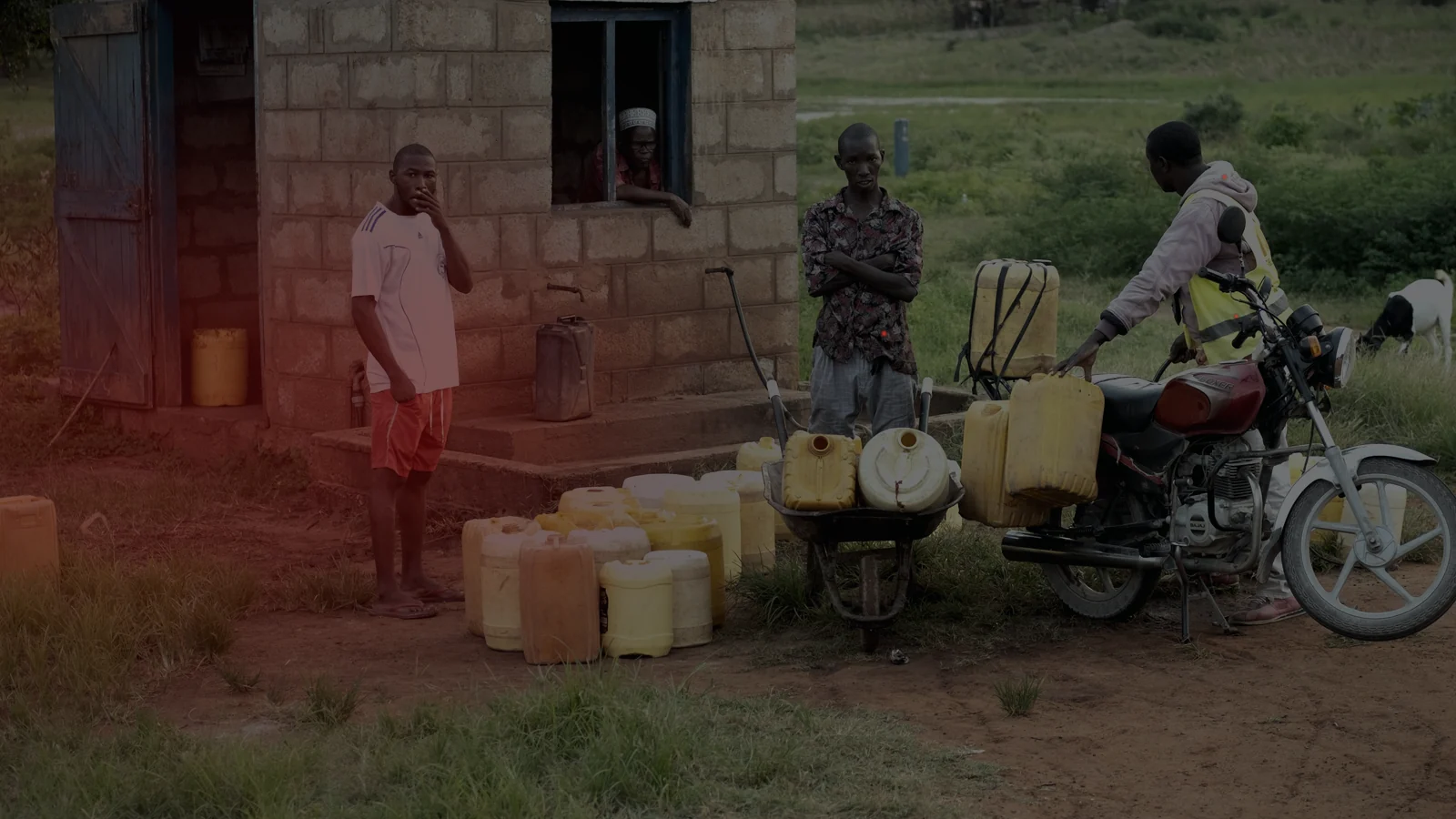 People gathered with containers at a community water point during a supply disruption